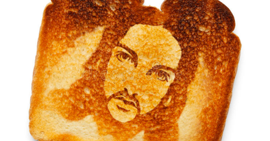 a photoshopped Jesus face appears burned into a piece of toast