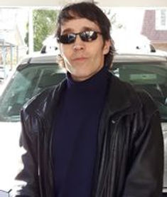 portrait of male investigator in leather jacket and sunglasses